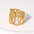 Gold ring with interlocking loops on a white background