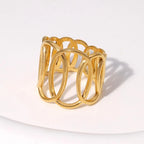 Gold ring with interlocking loops on a white background