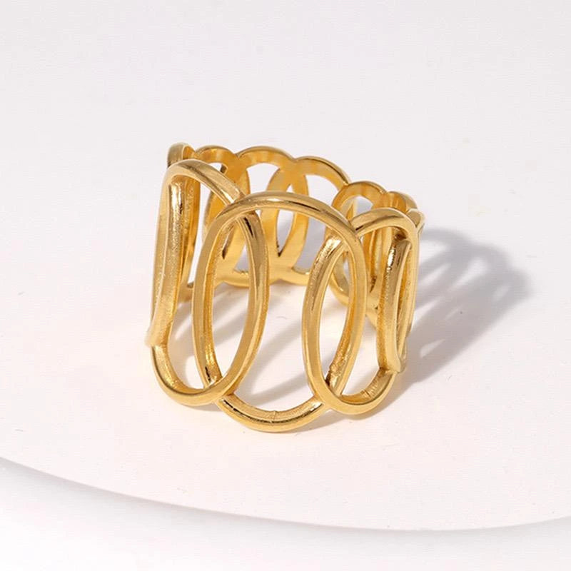 Gold ring with interlocking loops on a white background