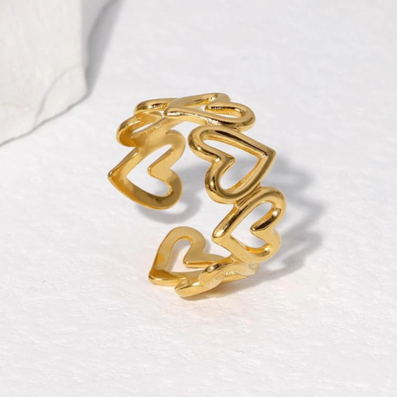 Gold heart-shaped ring on a white background