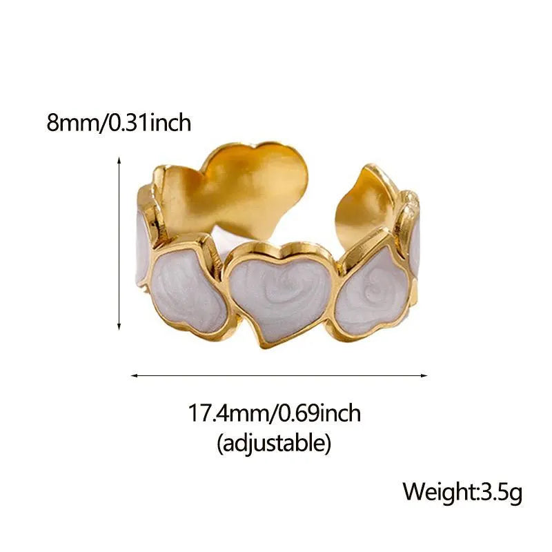 Gold and white heart-shaped ring with measurements and weight details on a white background
