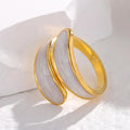Gold hoop ring on a white fabric background