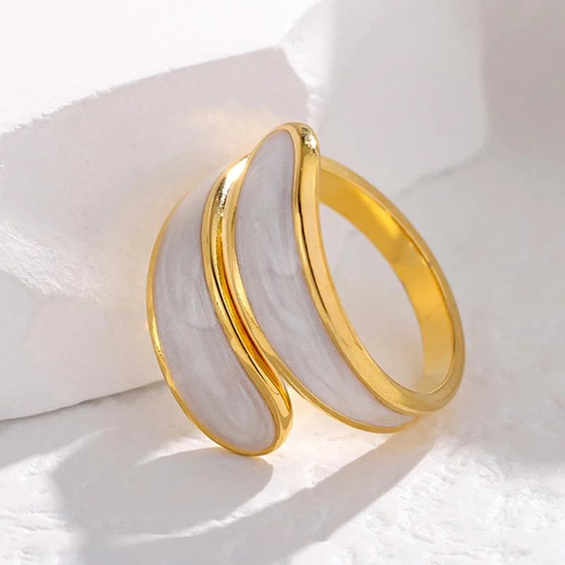 Gold hoop ring on a white fabric background