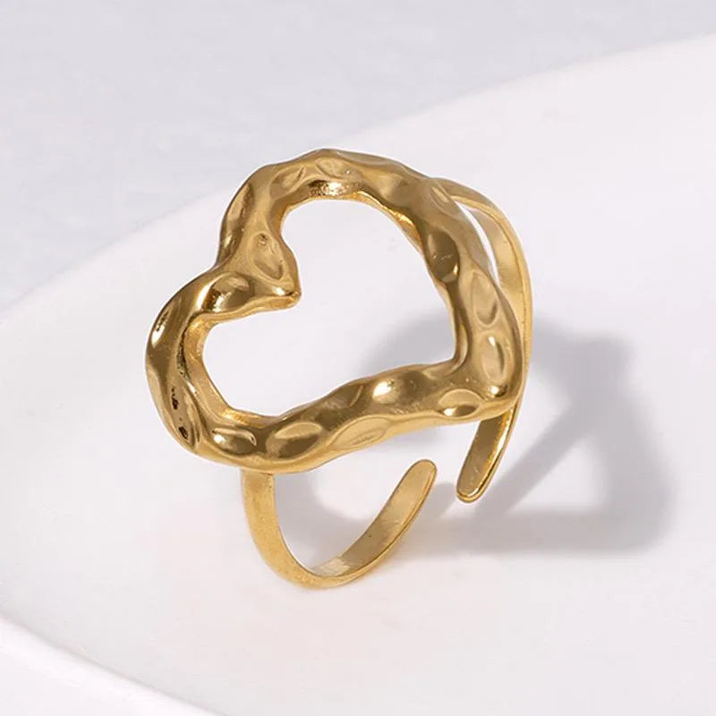 Gold ring with a textured design on a white background