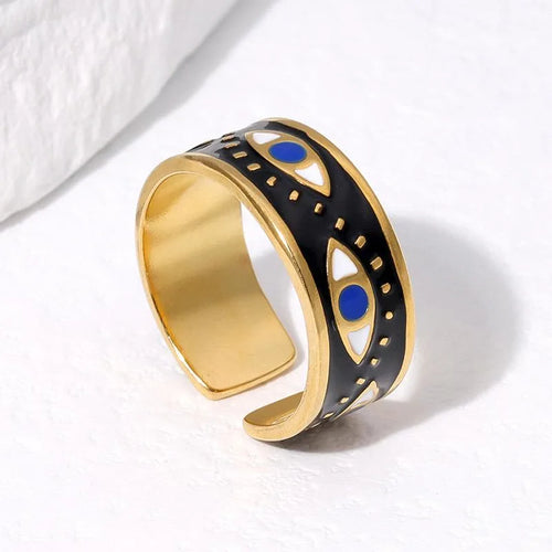 Gold and black ring with blue accents on a white background