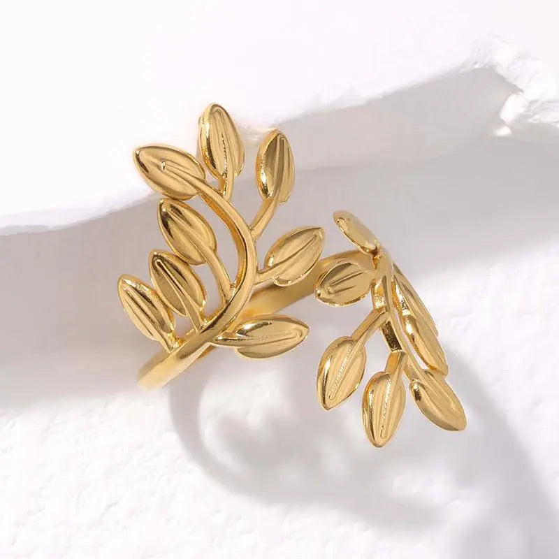 Gold leaf-shaped ring on a white background