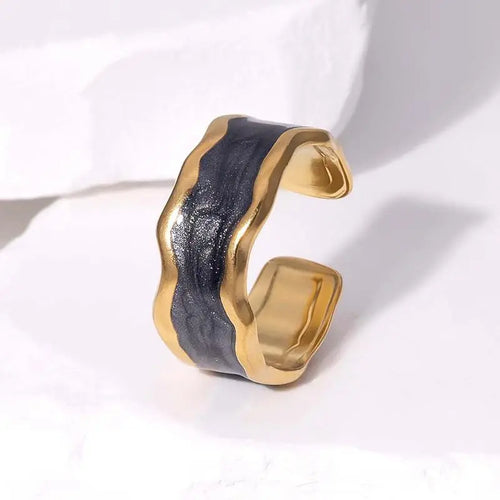 Gold and black ring on a white background