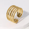 Gold ring with textured design on a white background